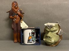 A selection of Star Wars collectables to include A Boba Fett mug, a Wookie and a Gamorrean Guard