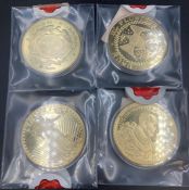 A selection of four collectable picture coins cupronickel plated in 24ct gold.