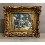 A gilt framed printed tile of blue and white ceramics