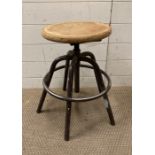 An industrial style wooden topped adjustable stool