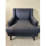 A contemporary chair in a navy pin stripe fabric (H85cm W86cm D80cm)