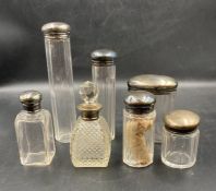 A selection of hallmarked silver topped dressing table jars