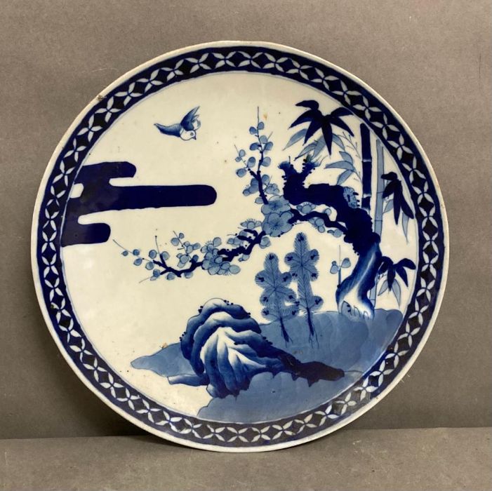 A Japanese blue and white charger with forest detail