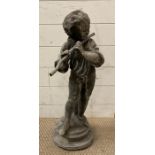 A lead garden figure of a young boy playing the flute