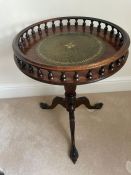 A mahogany galleried wine table with green leather top on down swept ball and claw feet