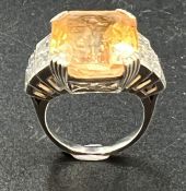 A Sri Lankan Octagonal cut peach sapphire approximately 17ct. With diamond shoulders and set on 18ct