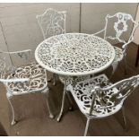 A white metal garden table and four companion chairs