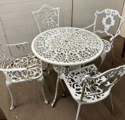 A white metal garden table and four companion chairs