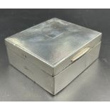 A silver cigarette box, hallmarked for Birmingham