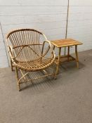A rattan/cane Mid Century arm chair and table