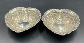 A pair of silver heart shaped pin dishes, hallmarked for London