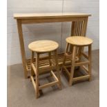 A contemporary pine breakfast bar and a pair of stools (H93cm W110cm D45cm) (Stool H61cm)