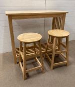 A contemporary pine breakfast bar and a pair of stools (H93cm W110cm D45cm) (Stool H61cm)