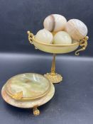 A trophy and gilt bowl with polished eggs and marble and gilt dish