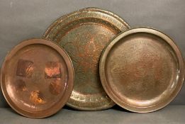 A selection of three hammered copper trays