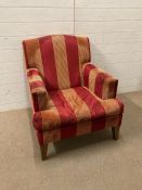 A red and gold upholstered lounge chair
