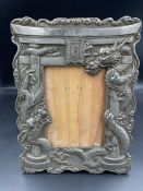 A Japanese antique dragon themed picture frame in white metal (24.5cm x 18.5cm)