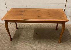 A yew coffee table on cabriole legs with string inlay