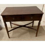 A mahogany side table and writing shelf with tapering legs and cross stretchers (H74cm W83cm D48cm)