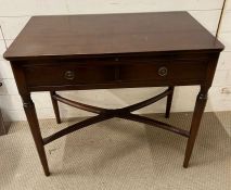 A mahogany side table and writing shelf with tapering legs and cross stretchers (H74cm W83cm D48cm)