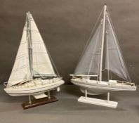 Two mounted wooden model yachts