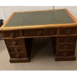 A pedestal desk with carved lion head handles and green leather top (H77cm W122cm D74cm)