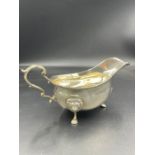 A silver sauce boat for Harrods, hallmarked for London 1959 (Approximate weight 227g)