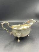 A silver sauce boat for Harrods, hallmarked for London 1959 (Approximate weight 227g)
