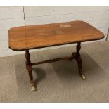 A mahogany coffee table with turned stretcher on splayed legs with lions paw feet with brass inlay