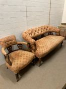 A Victorian mahogany button back arm chair and sofa on castors