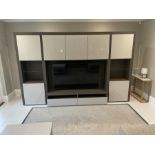 A large media unit with high gloss white doors