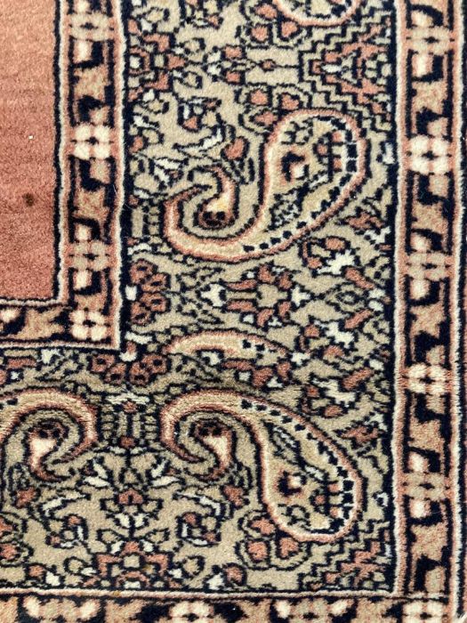 A brown ground wool rug with central medallion and geometric border red and blues (130cm x 210cm) - Image 12 of 12