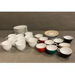 Nine Coloured expresso cups with nine saucers and ten white expresso cups and saucers.