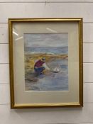 A framed watercolour of a boy with his boat signed bottom left
