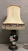 A ceramic blue table lamp with floral detail