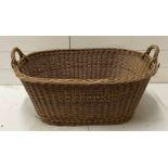 A vintage two handled wicker basket