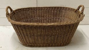 A vintage two handled wicker basket