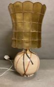 A ceramic hand painted table lamp with a vintage capiz shell shade