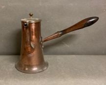 A copper wooden handled coffee pot