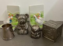 A selection of nursey money boxes, Christening Cups and china book ends