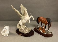Three equine figurines to include Pegasus, mother with foal and a resting horse