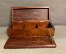 A mahogany box containing a cribbage board and four brass counters AF