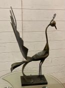A contemporary metal sculpture of a peacock