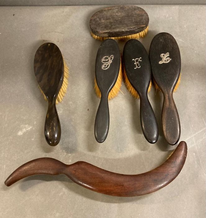 A selection of vintage hair brushes and a top hat brush