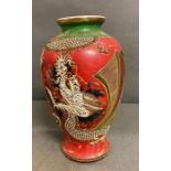 An oriental red, gold and green vase with dragon motif stamped to base