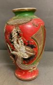 An oriental red, gold and green vase with dragon motif stamped to base