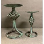 Two cast iron candle stick holders with parallelized detail