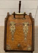 A farm house oak and brass coal scuttle bin with metal liner