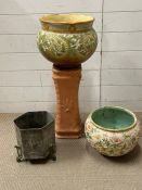 A selection of ceramic and brass plant pots