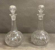 A pair of cut glass shaft and grobe decanters